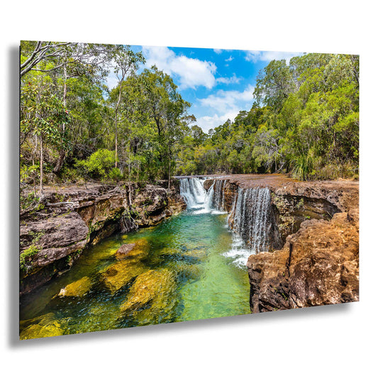 a waterfall in the middle of a forest
