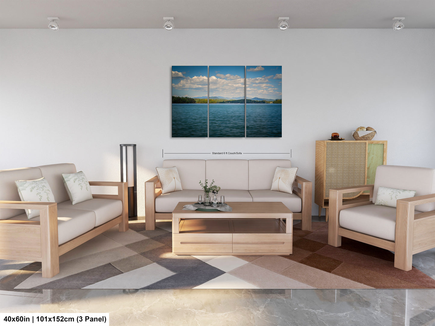 The image is a modern living room with a large, three-panel landscape painting depicting a serene lake scene with a blue sky and fluffy clouds. The room is furnished with a sofa, two armchairs, and a coffee table, creating a comfortable and inviting atmosphere.
