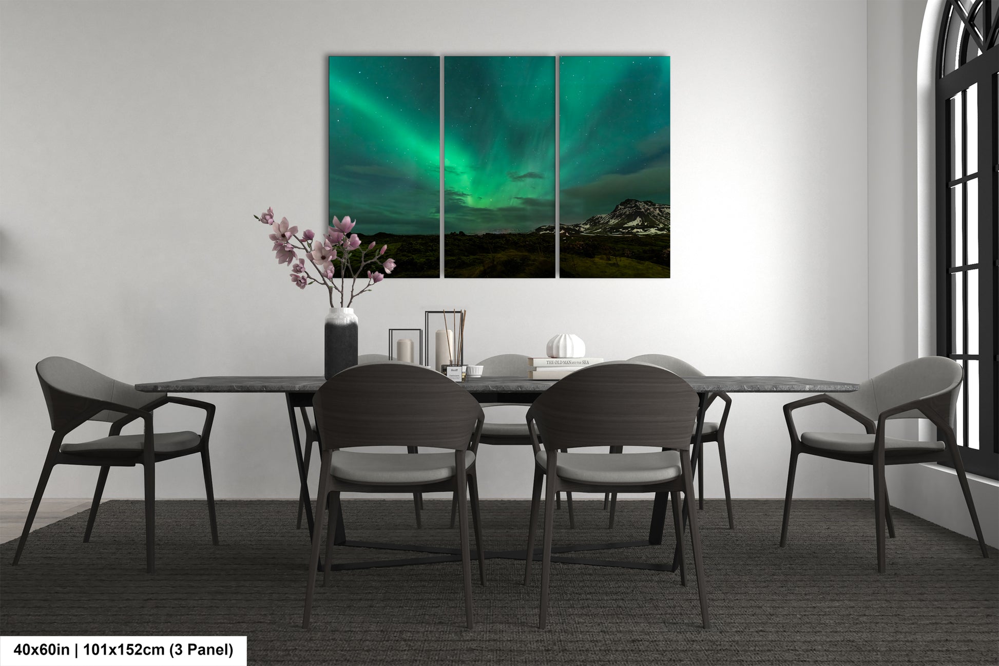 a room with a table and chairs and a painting on the wall