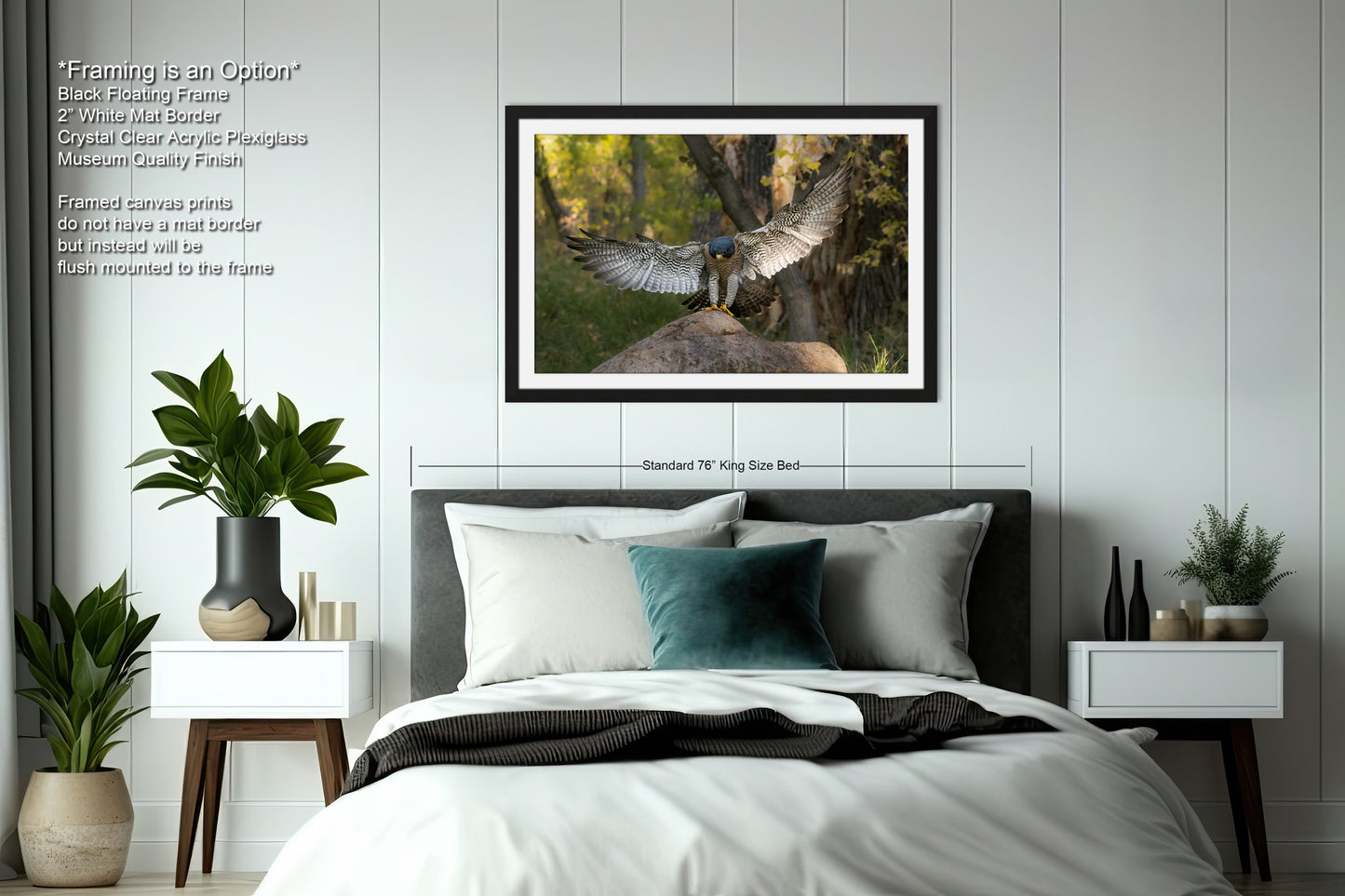 a bedroom with a large framed photograph of a bird with outstretched wings hanging on the wall above a bed with white sheets and a green pillow.