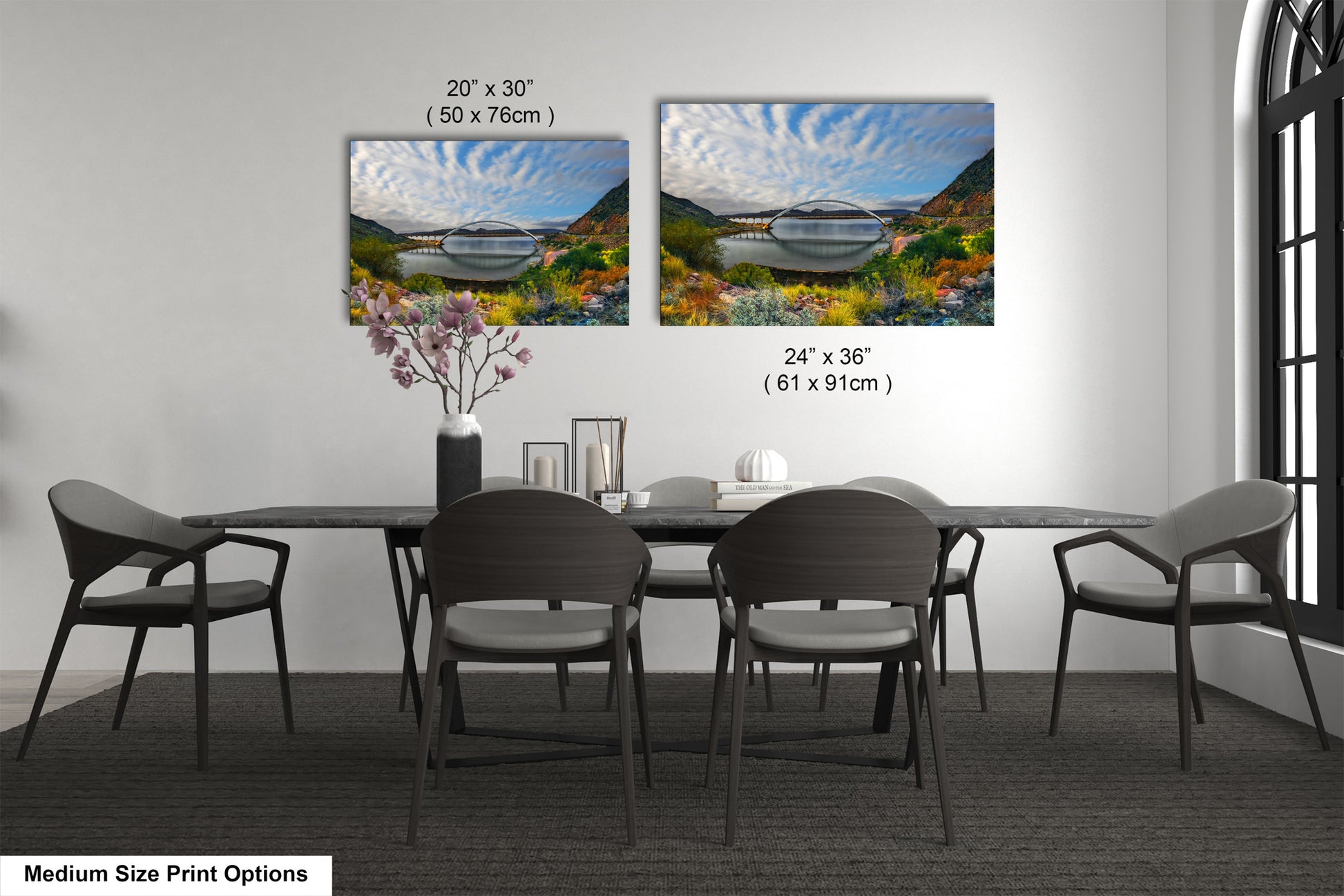 a dining table with four chairs and a vase with flowers