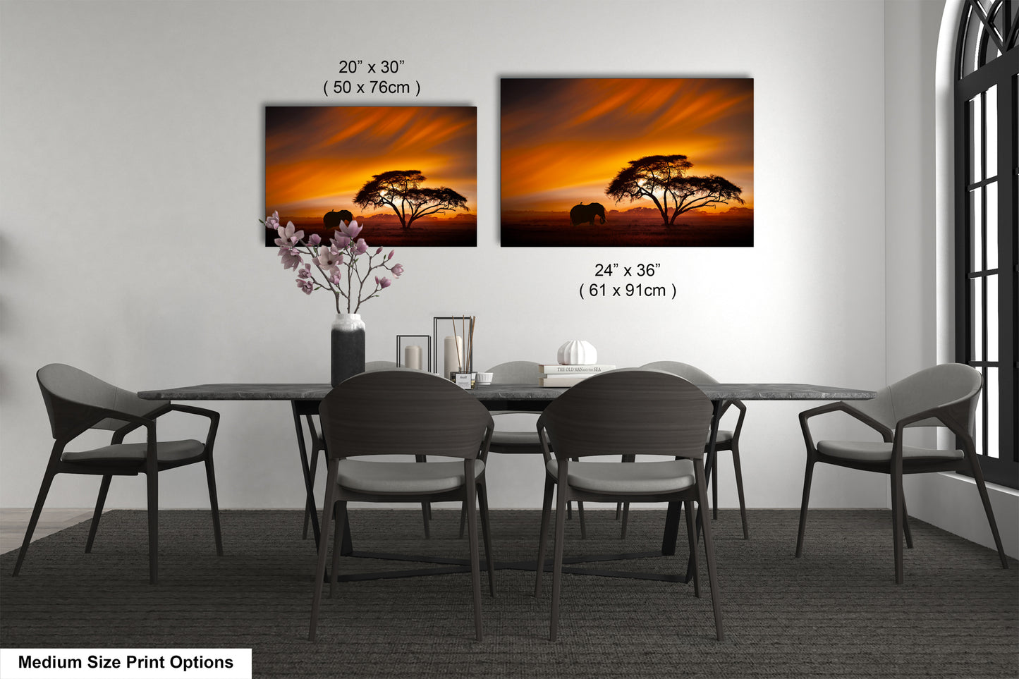 a dining table with four chairs and a vase with flowers