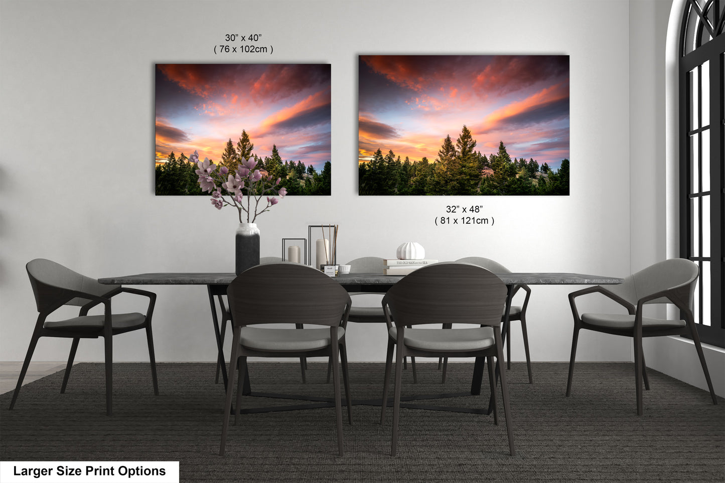 a dining room table with four chairs and a vase of flowers