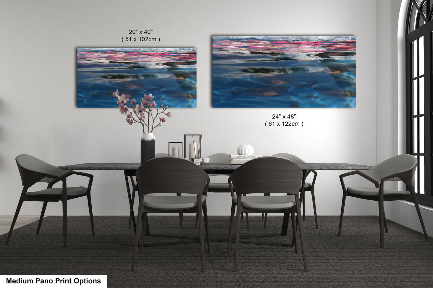 a dining room table with four chairs and a painting on the wall