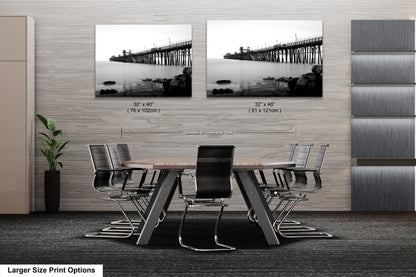 a dining room table with chairs and a picture of a bridge