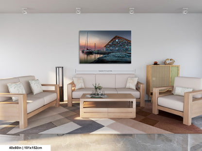 a living room with a large painting of a boat on the wall, a sofa, a coffee table, and a rug.