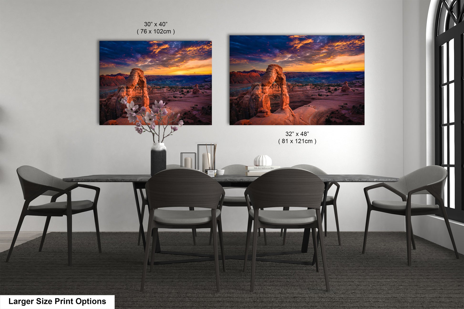 a dining room table with four chairs and two pictures on the wall
