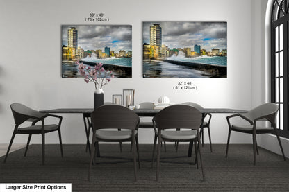 a dining room table with chairs and a vase of flowers