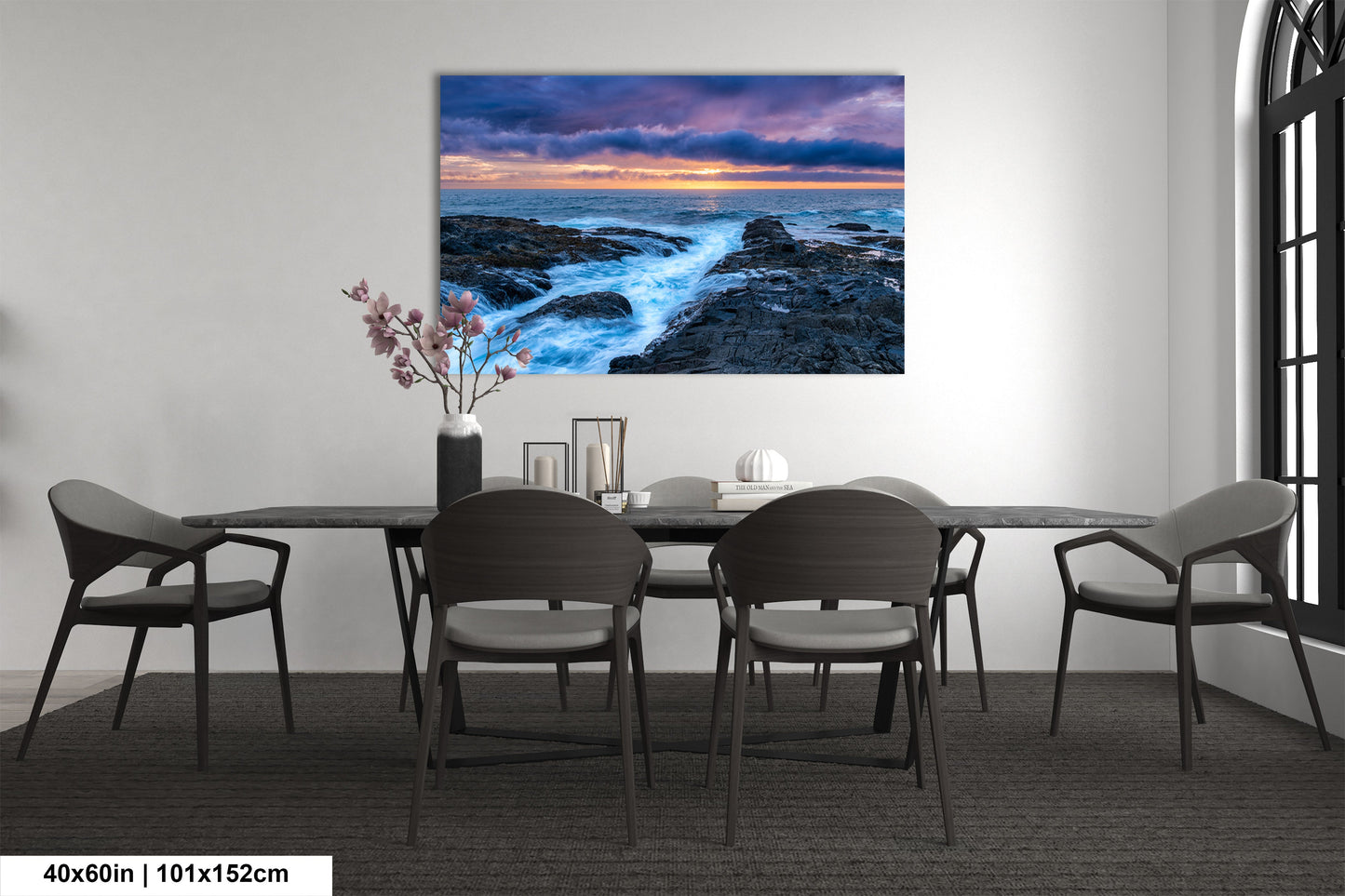 a dining room table with chairs and a painting on the wall