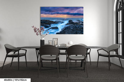 a dining room table with chairs and a painting on the wall