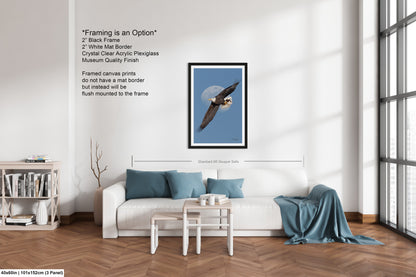 The image is a modern living room with a white sofa, a coffee table, and a bookshelf. There is a framed picture of a bald eagle on the wall, and a window with white blinds. The room has a minimalist and clean design, with a focus on the white furniture and the large window providing natural light.