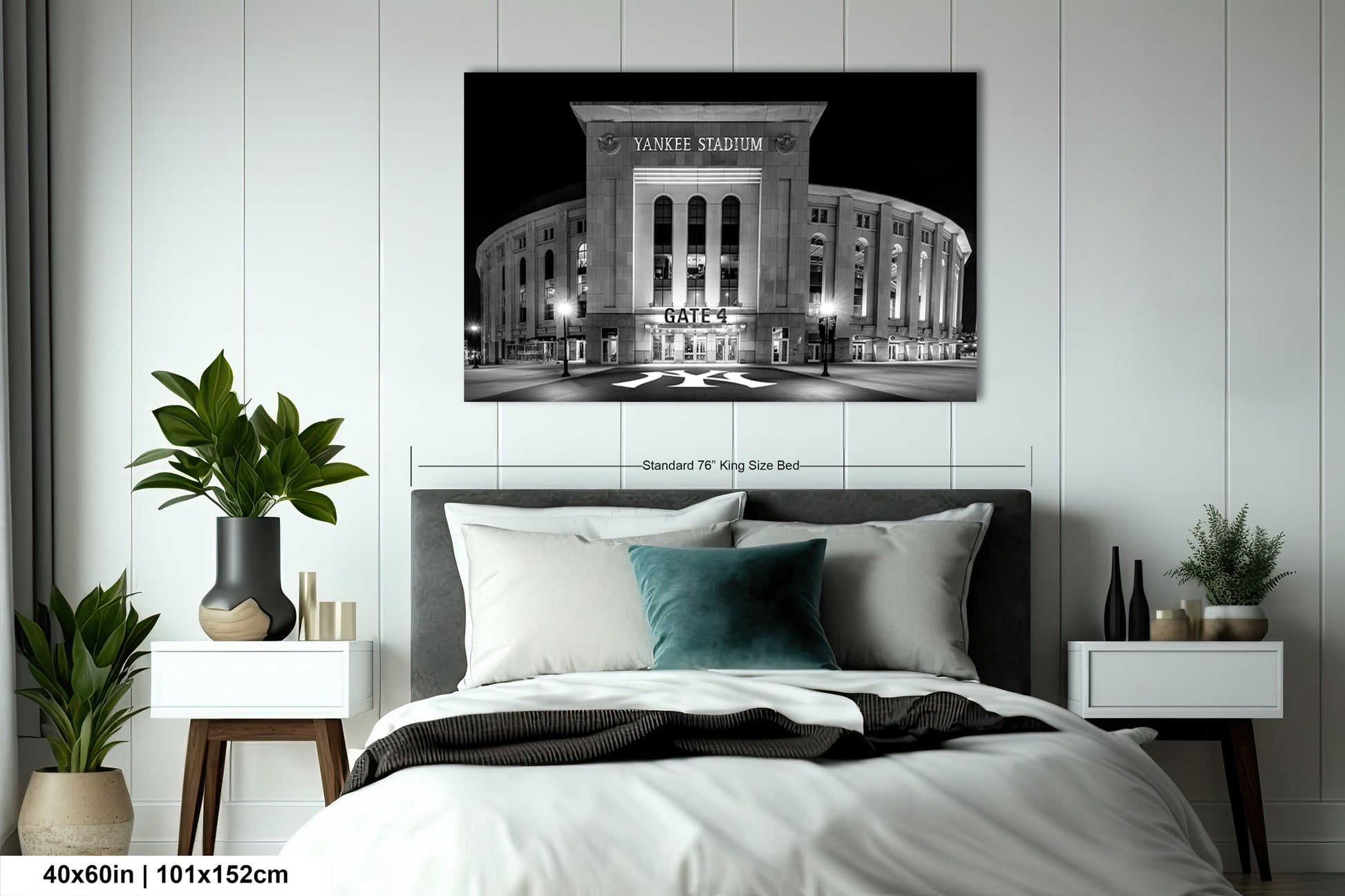 A bedroom with a large bed, nightstands, and a framed photograph of Yankee Stadium hanging on the wall.