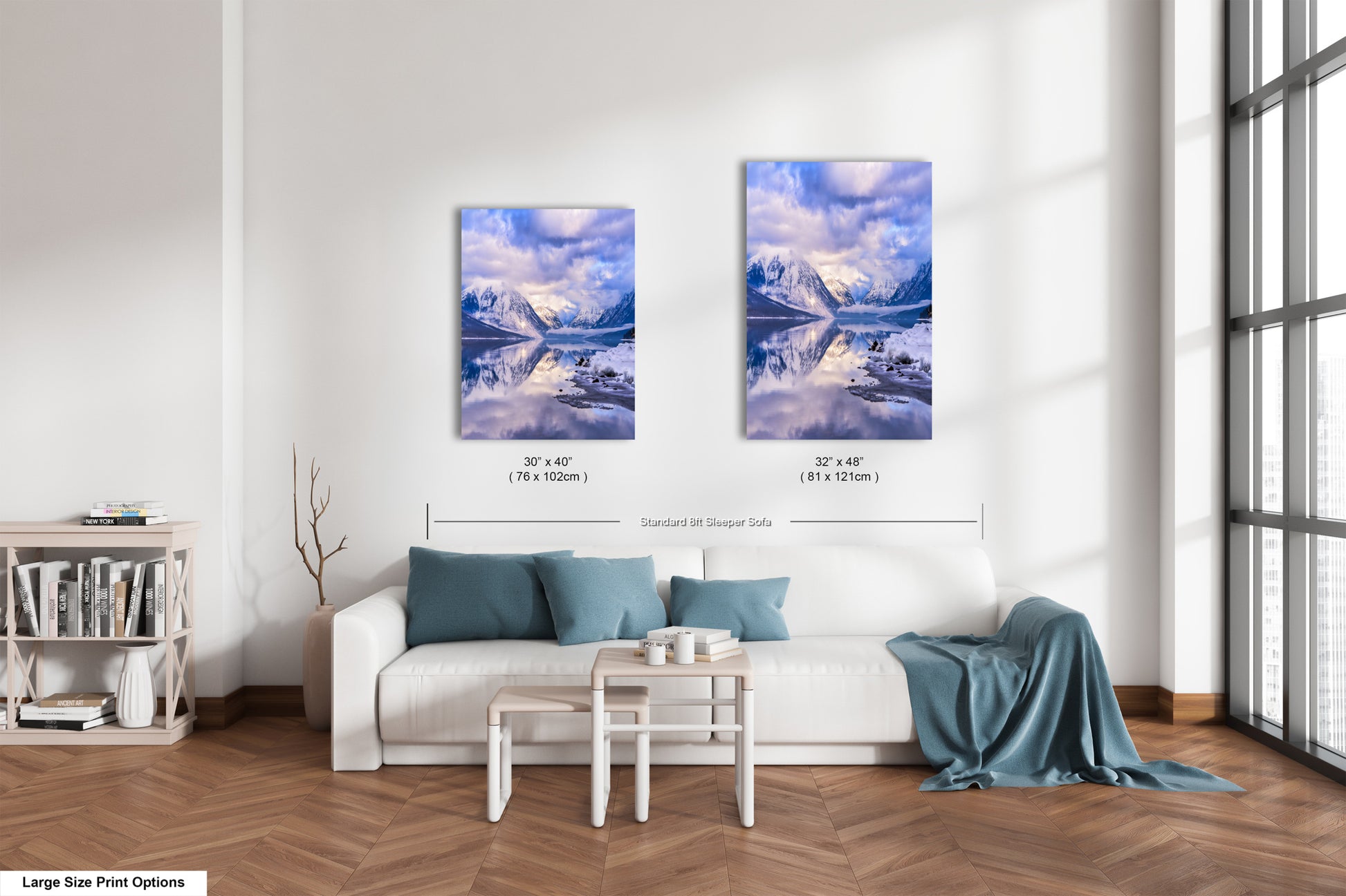 a living room with a white couch and two pictures on the wall