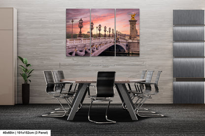 a dining room table with chairs and a painting on the wall