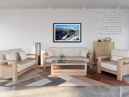 a modern living room with a large framed landscape photograph hanging on the wall. The room is furnished with a sofa, two armchairs, and a coffee table, creating a cozy and inviting atmosphere.