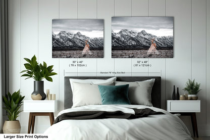 a bed with two pictures on the wall above it