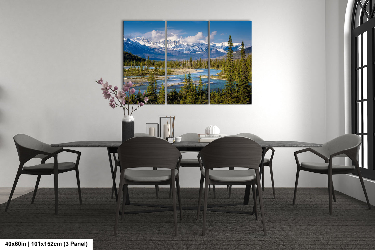 a dining room table with four chairs and a painting on the wall