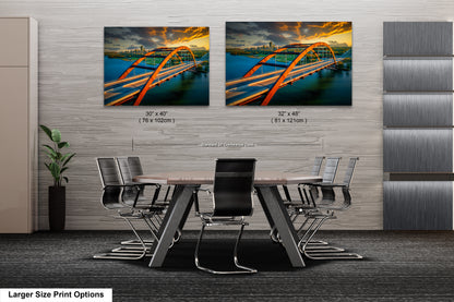 a dining room table with chairs and a painting of a bridge