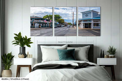 a bedroom with a bed and two paintings on the wall