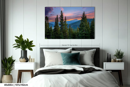 a serene bedroom scene with a large bed, nightstands, and a painting of a forest landscape hanging on the wall.