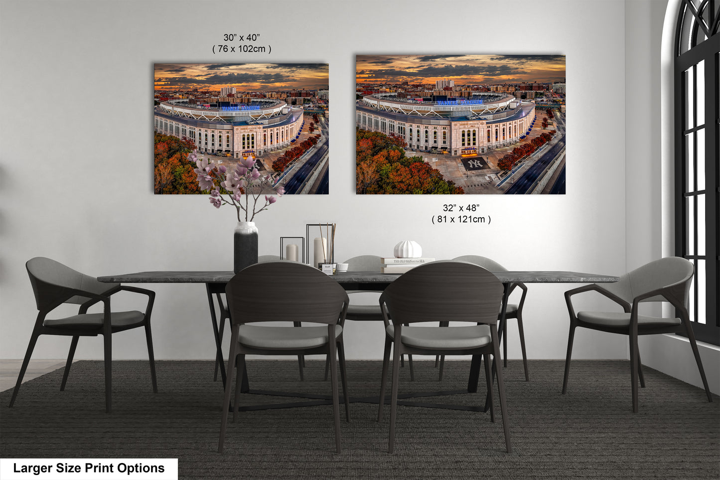 a dining room table with four chairs and two pictures on the wall