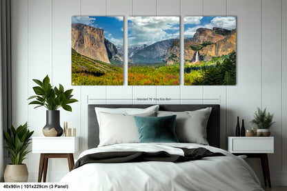 a bed room with a neatly made bed and two pictures on the wall
