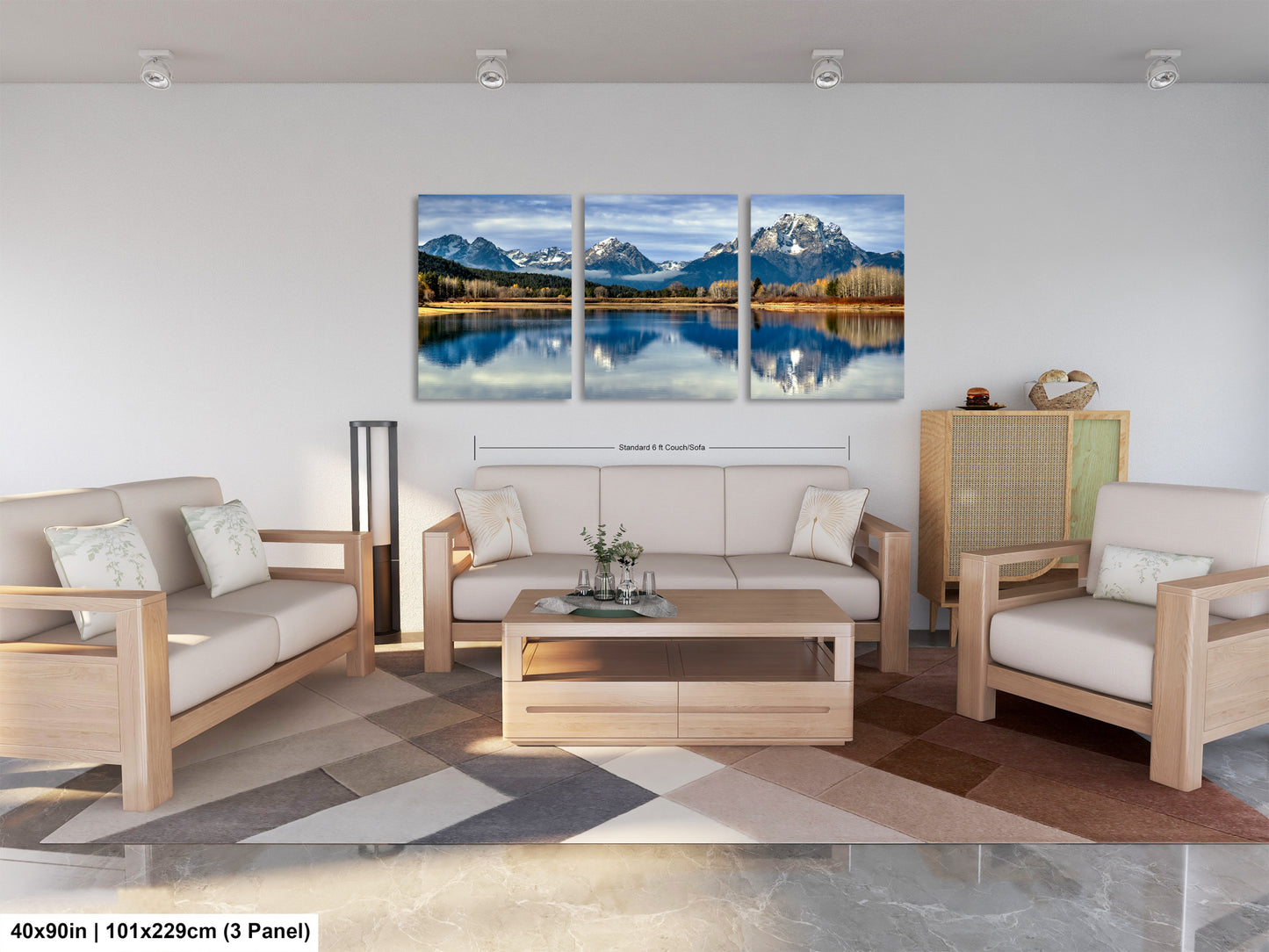 The image is a modern living room with a large, three-panel landscape painting hanging on the wall. The painting depicts a serene mountain lake surrounded by trees and mountains, creating a peaceful and natural atmosphere. The room is furnished with a sofa, two chairs, and a coffee table, providing a comfortable and inviting space for relaxation and socializing.