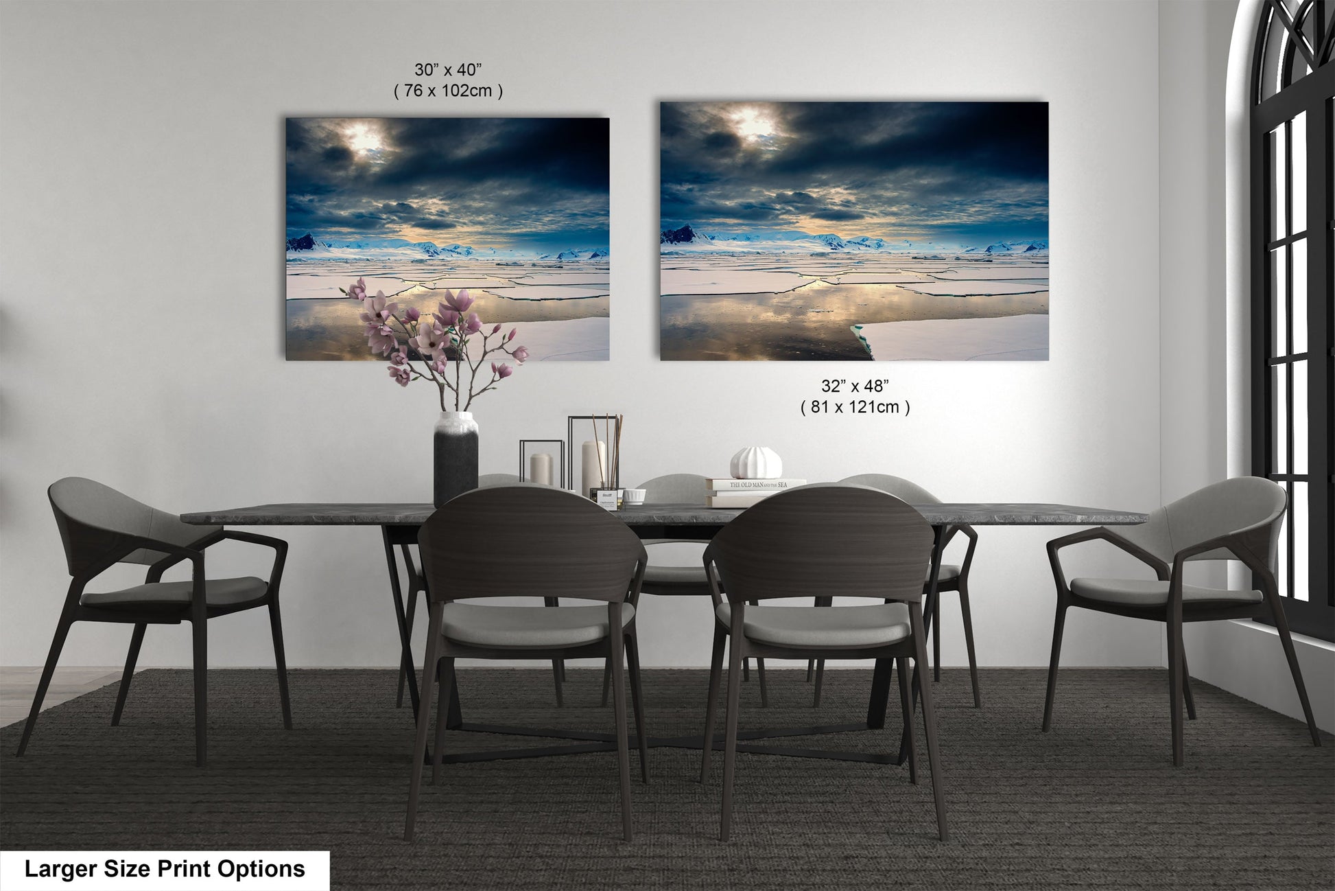 a dining table with four chairs and a vase of flowers