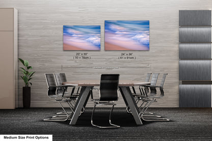 a dining room table with chairs and two pictures on the wall