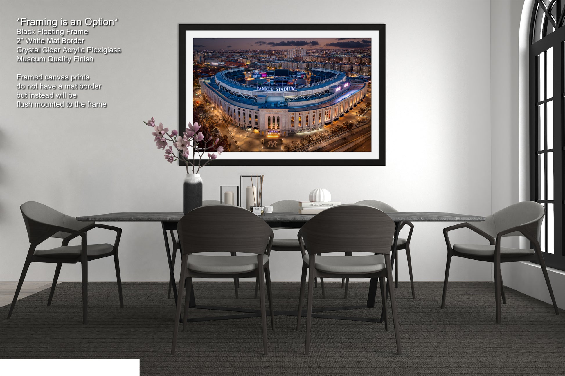 a dining room table with chairs and a picture hanging on the wall