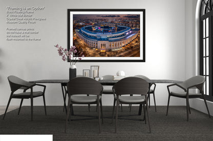 a dining room table with chairs and a picture hanging on the wall