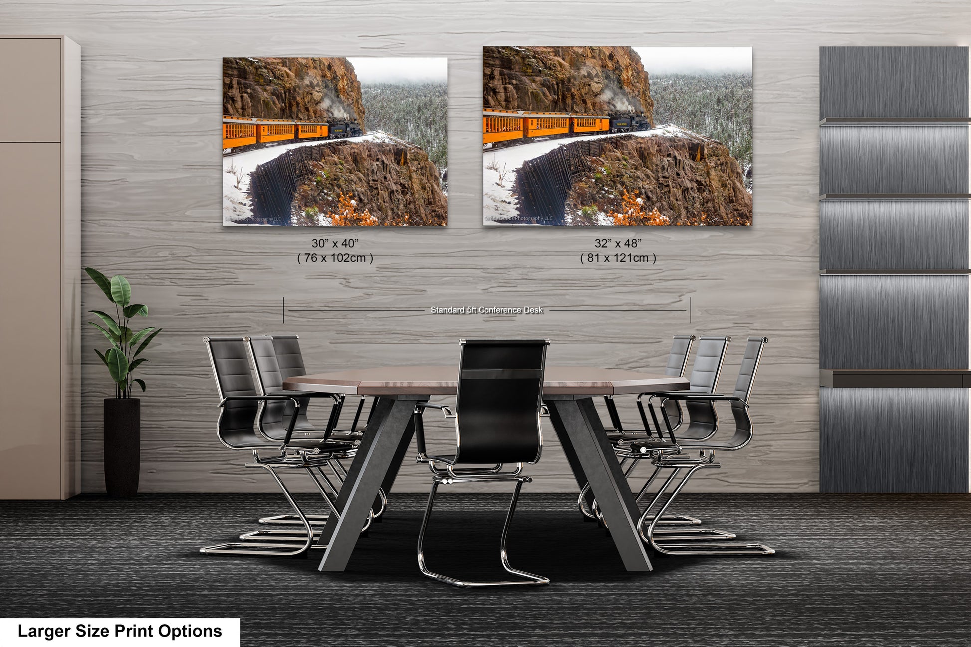 a dining room table with chairs in front of a wall with a picture of a