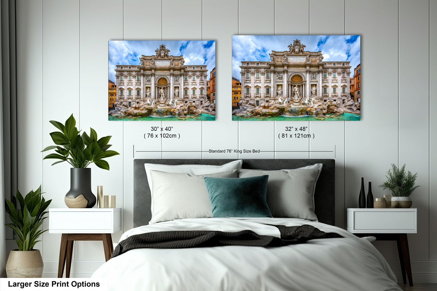 a bed with a white comforter and two pictures on the wall