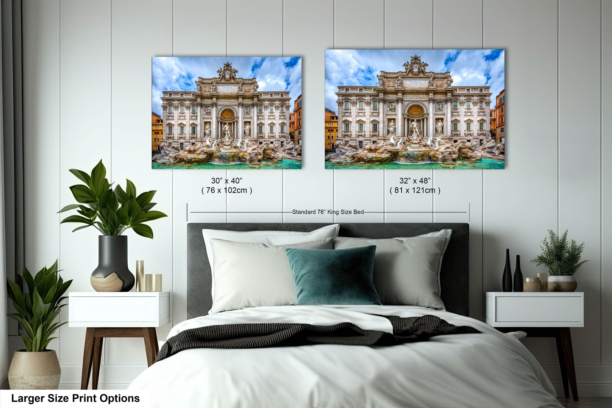 a bed with a white comforter and two pictures on the wall