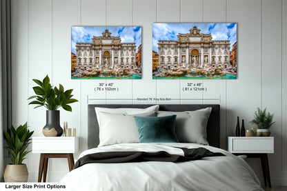 a bed with a white comforter and two pictures on the wall