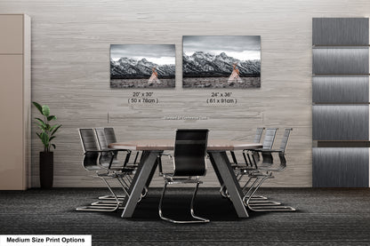 a dining room table with four chairs and two pictures on the wall