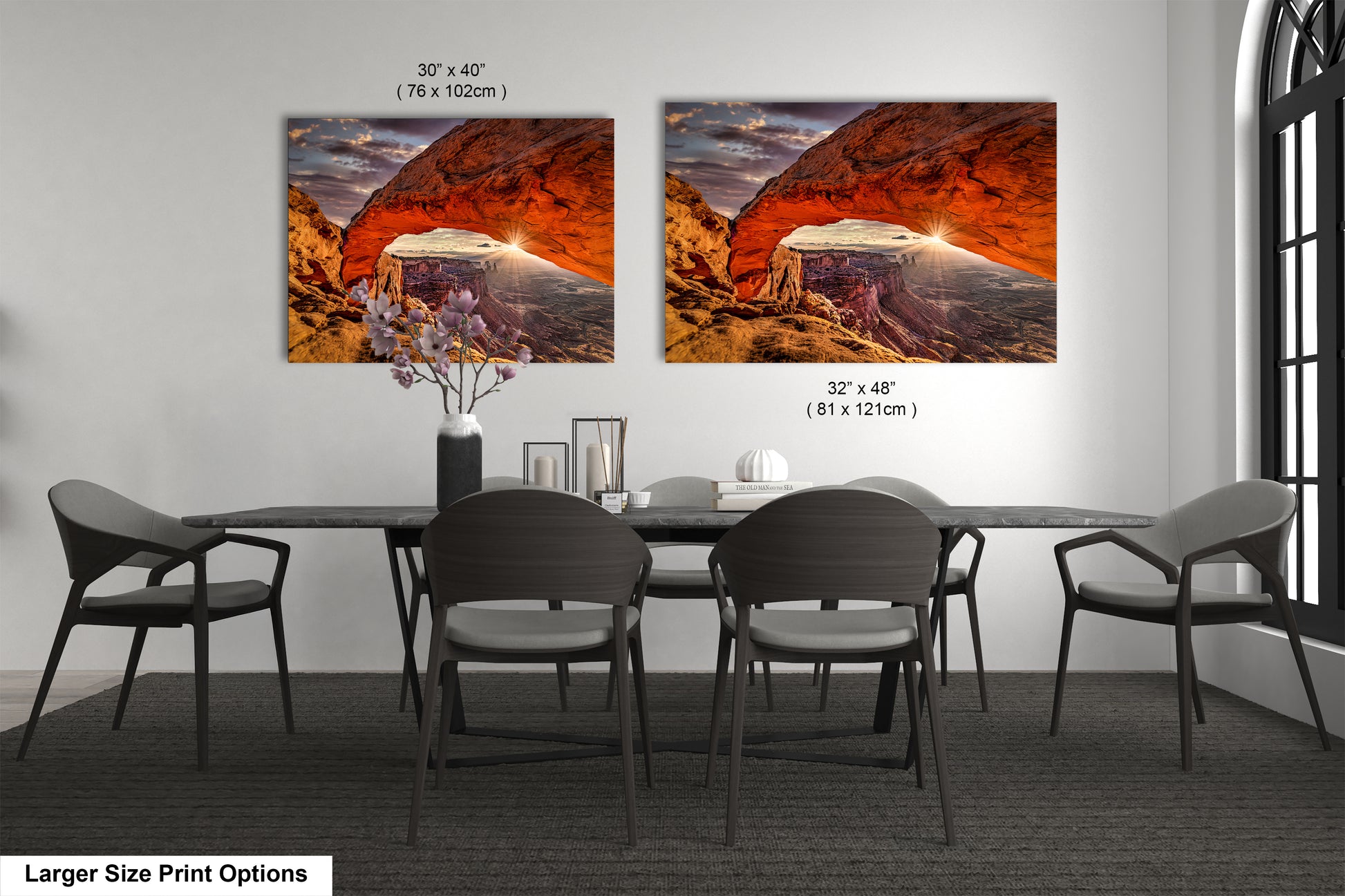 a dining room table with four chairs and two pictures on the wall