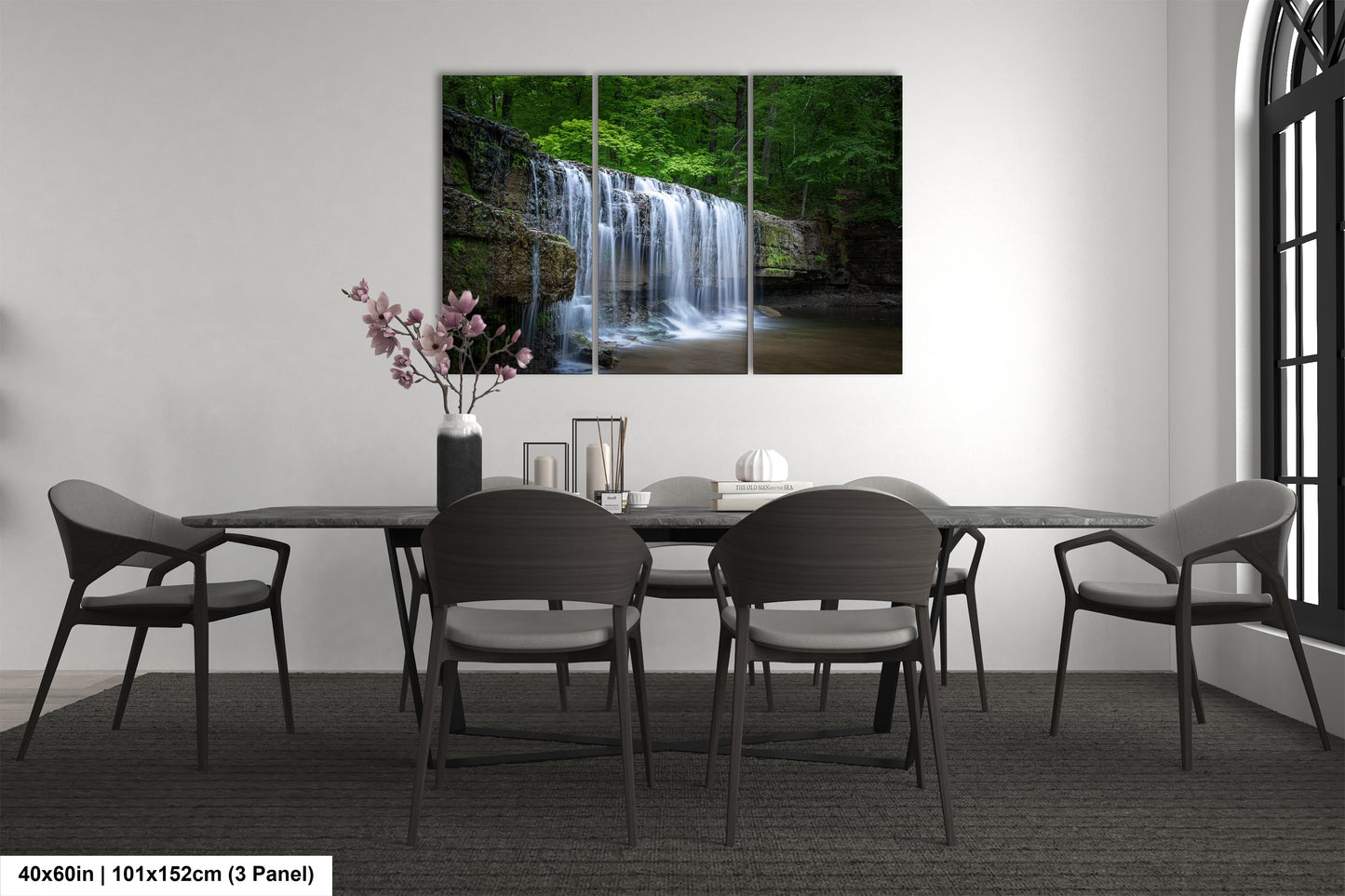 a dining room table with a waterfall in the background