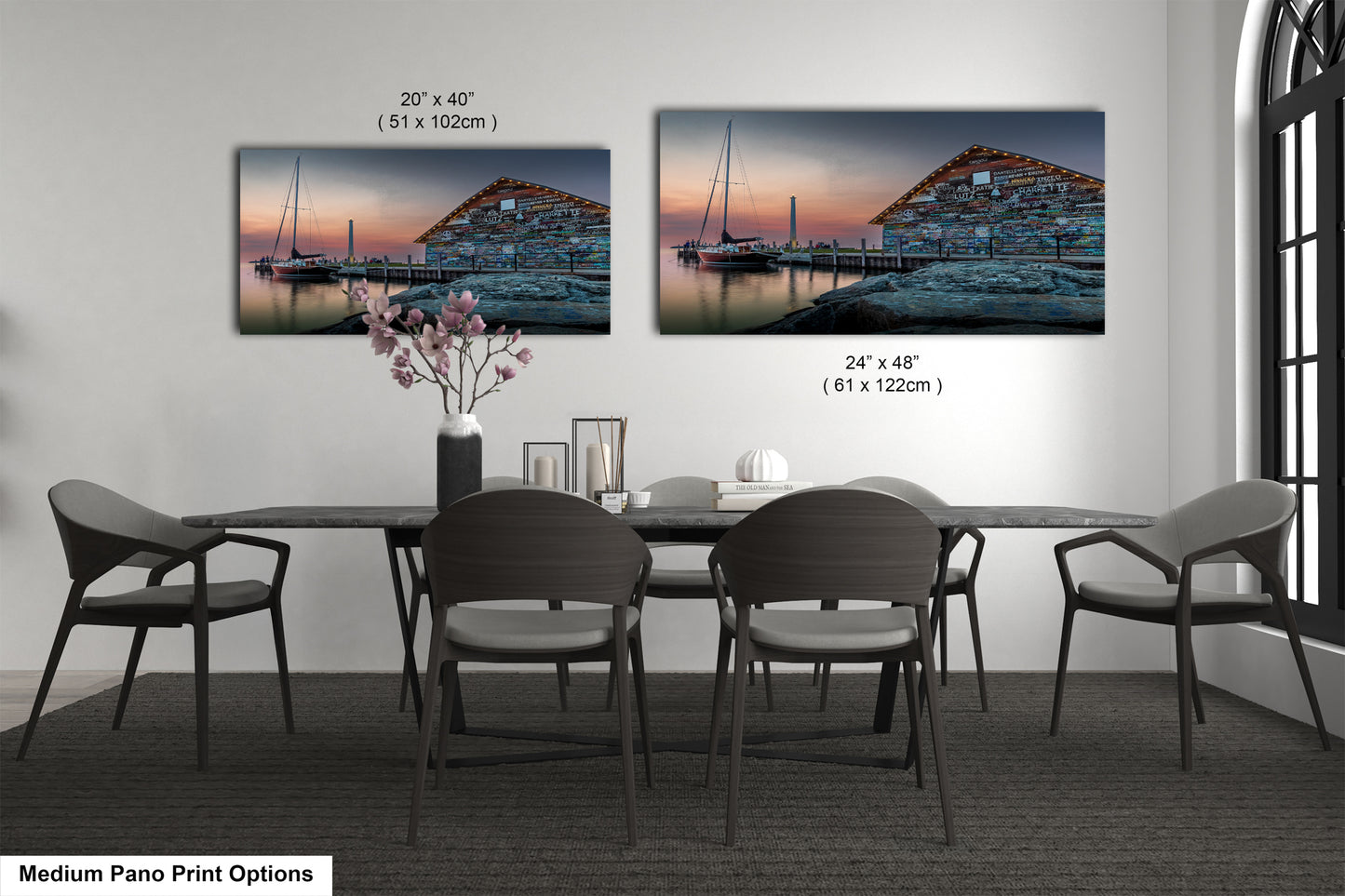 a bedroom with a bed and nightstands, along with two framed prints of a seascape displayed on the wall above the bed.