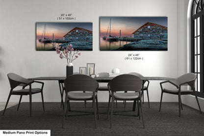 a bedroom with a bed and nightstands, along with two framed prints of a seascape displayed on the wall above the bed.