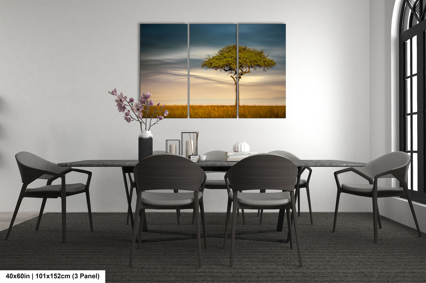 a dining room table with chairs and a painting on the wall
