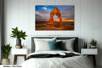 a bed room with a neatly made bed and a painting on the wall