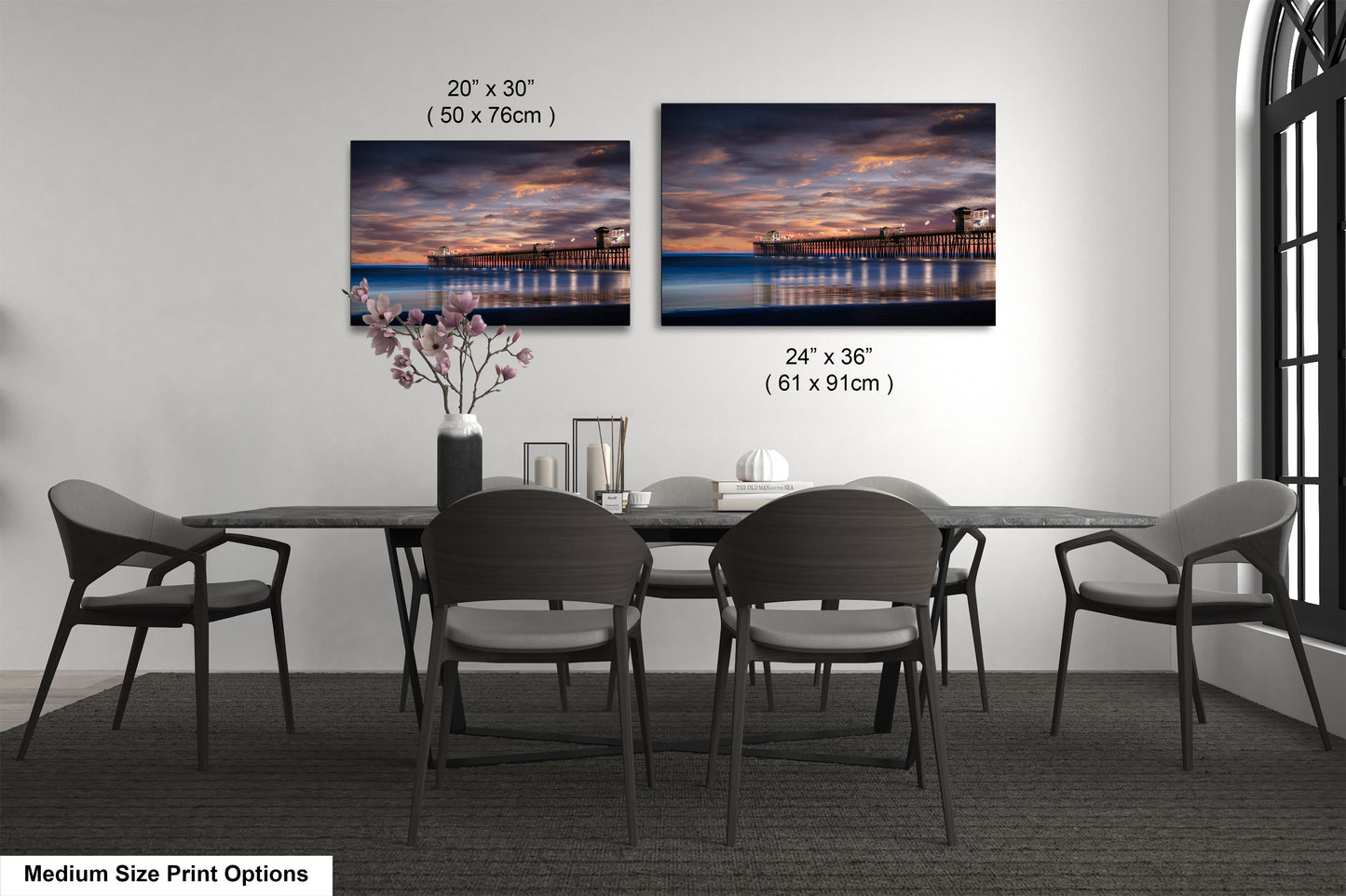 a dining room table with chairs and a vase of flowers