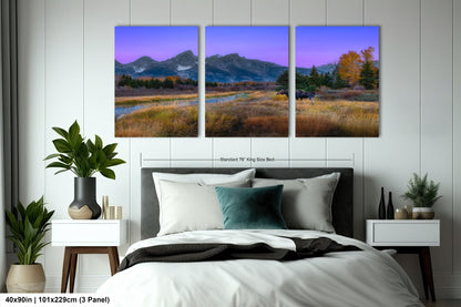a bedroom with a bed and two paintings on the wall