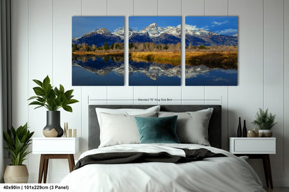 a bed room with a neatly made bed and three pictures on the wall
