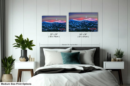 a bedroom with a bed and two pictures on the wall