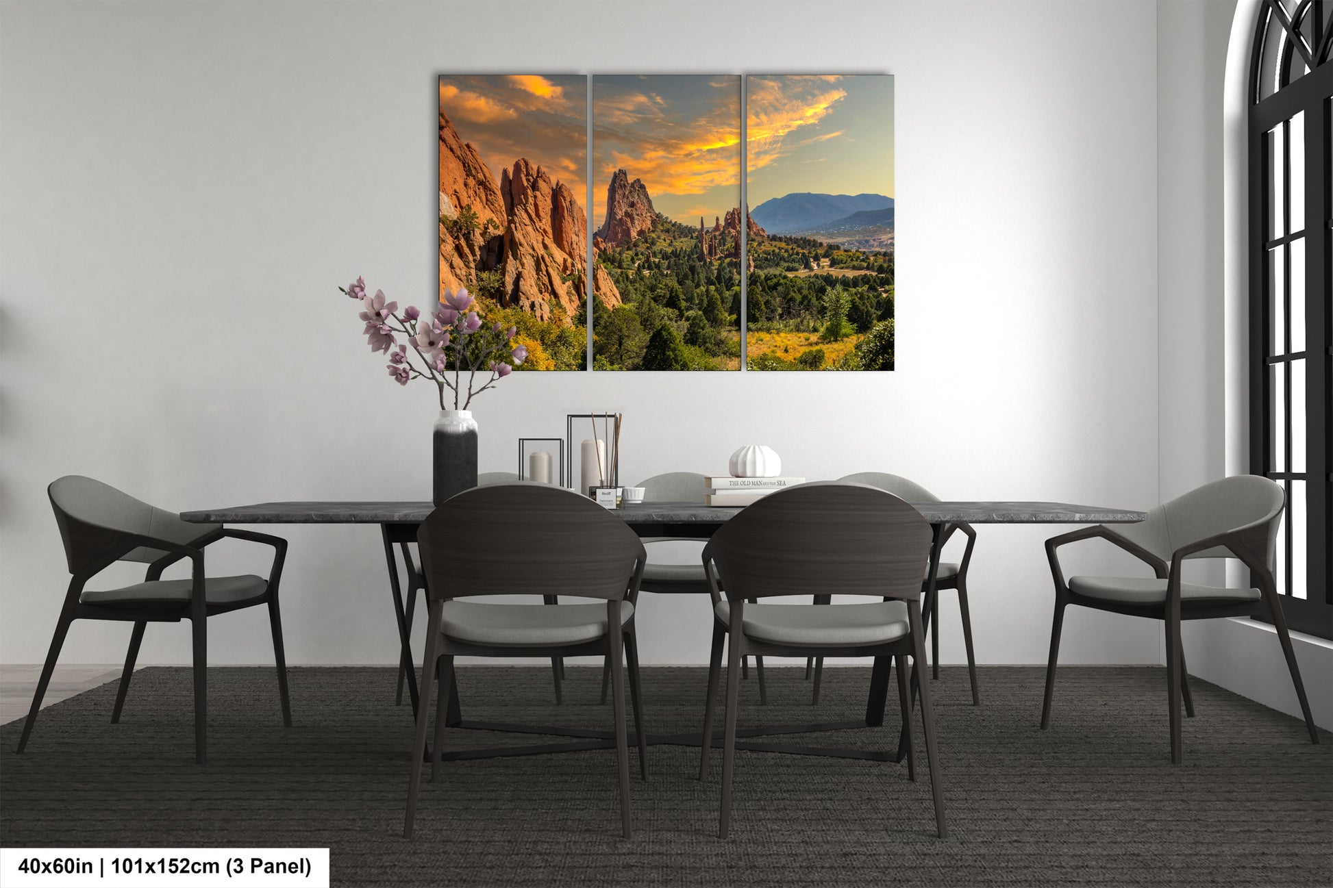 a dining room table with chairs and a painting on the wall