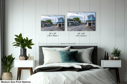 a bedroom with a bed and two pictures on the wall