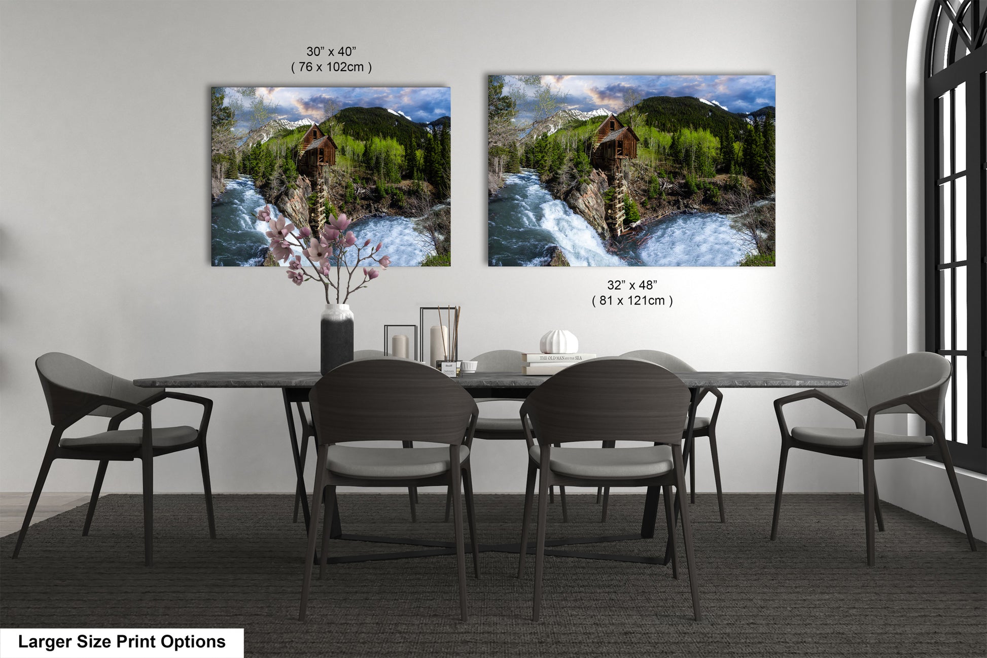 a dining room table with four chairs and two pictures on the wall