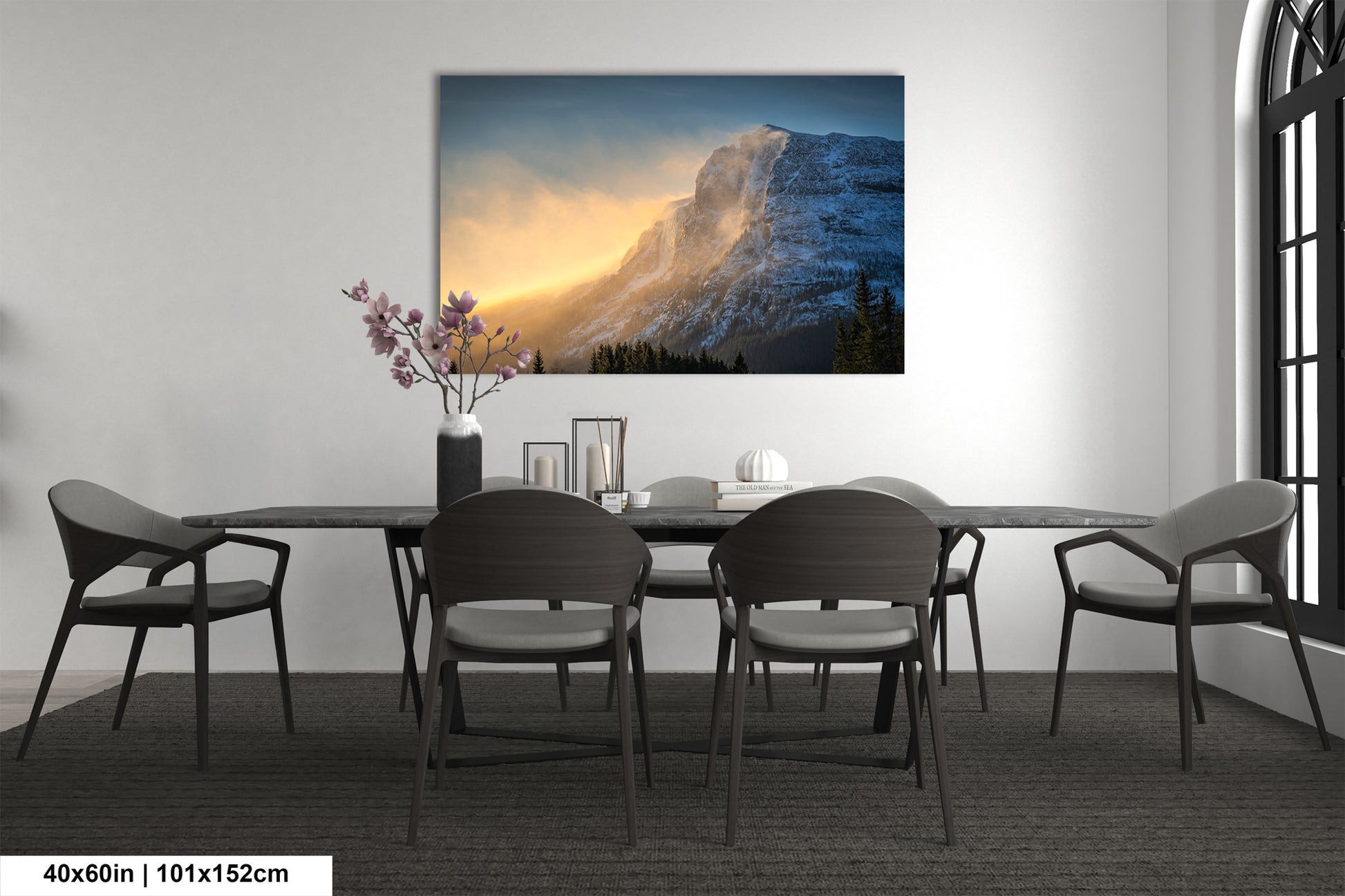 a dining room table with chairs and a painting on the wall